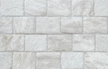 Closeup surface brick pattern at old gray stone brick wall texture background at the fence of house