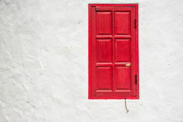 red window on white wall