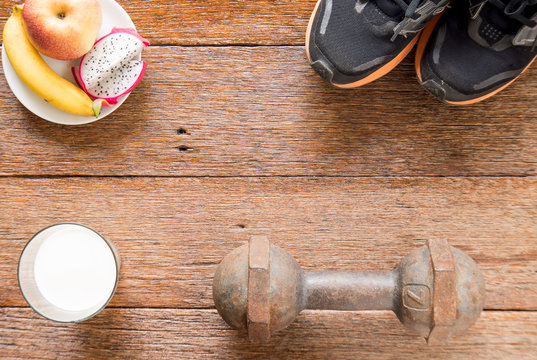 Iron dumbbell,Sports shoes and  milk with fruit (banana,appke,dr