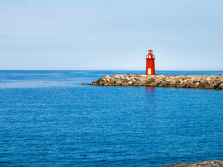 Red lighthouse at the port of entry reporting