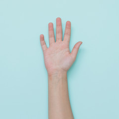Trendy style of one clean hand on light blue background.