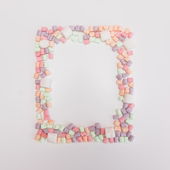 Sweets in shape of square frame on pastel backgrounds. Fashion style Minimalism Set. Flat lay, Top view.