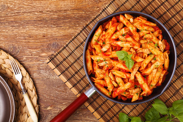 Penne with roasted chicken in tomato sauce