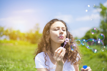 Young woman blowing bubbles