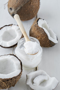 coconuts with coconut oil on white table