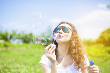 Young woman blowing bubbles