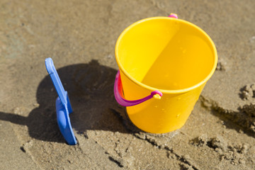 Fototapeta na wymiar Toy Spade and Bucket in Sand