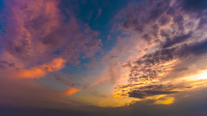 The beautiful sunset on the background of cloud stream. Wide angle