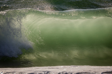 Tubular shore waves breaking in late afternoon back-light, Nahariya beach