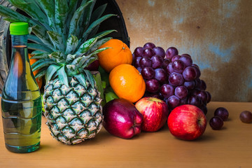Pineapple and fresh fruits on a wooden