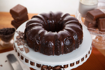 Delicious rich sweet chocolate bundt cake whole complete on a stand