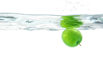 Fototapeta na wymiar Water splash. Green apple under water. Air bubble and transparen