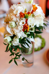 Tender bouquet of pink, peach and white roses stands in the glas