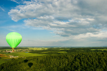 Hot air balloon over the field with blue sky