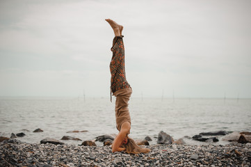 woman standing on her head doing yoga