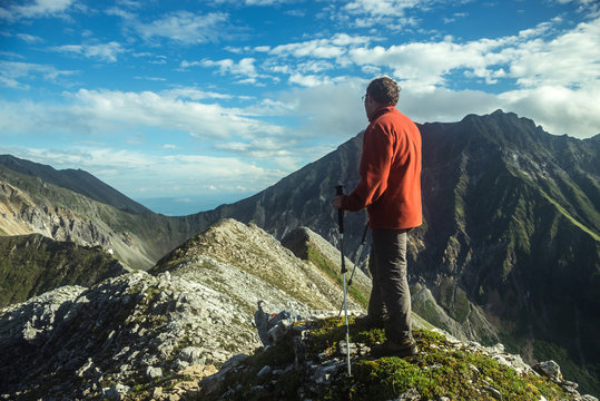 man climbs a mountain at the beautiful view