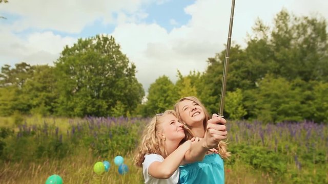 Two girls doing selfi with selfi stick