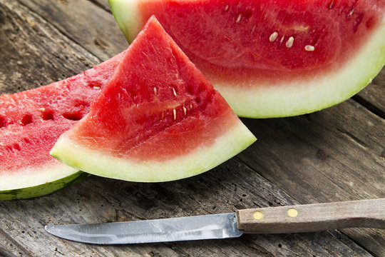 pieces of watermelon on wooden background.