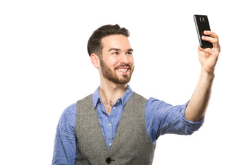 Young man taking selfie picture with smart-phone