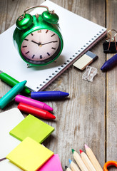 Assortment of office and school supplies on wooden table