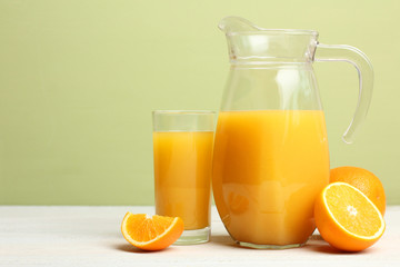 Fototapeta na wymiar a carafe of orange juice on wooden background