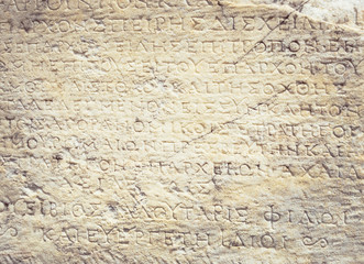 Texture background with greek inscription on the wall.