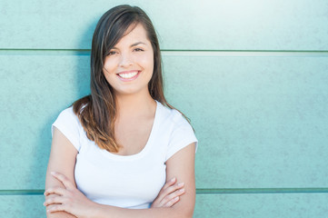 Pretty girl smiling and posing with arms crossed