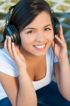 Portrait of girl listening to music on headphones
