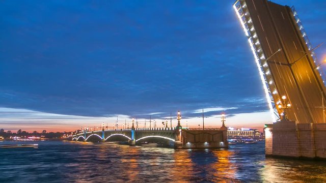 Opening Trinity bridge timelapse and pleasure boats are on Neva river in Saint-Petersburg, Russia.