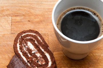Chocolate cake slice with coffee cup