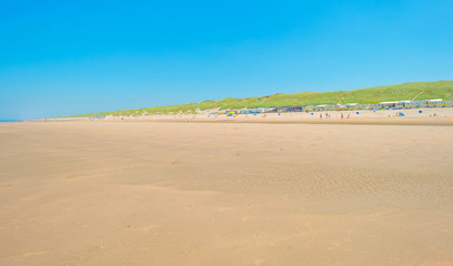 Fototapeta na wymiar Blue sky over a beach along a sea