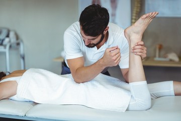 Physiotherapist giving hip massage to a woman