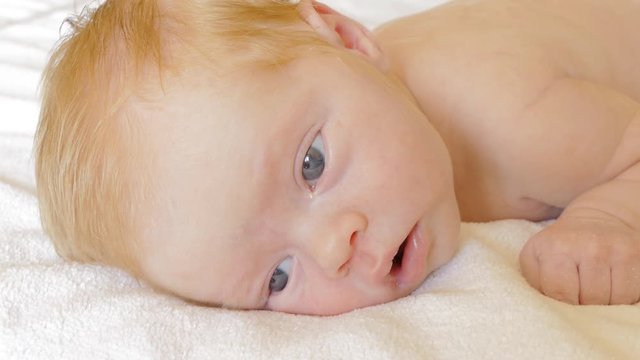 A newborn baby looks and emotes , 5 day