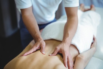 Fototapeta na wymiar Physiotherapist giving back massage to a woman