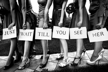 Girls hold a lettering 'Just wait till you see her' by their pre