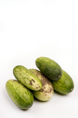 Fresh cucumbers dirty with soil isolated over white background