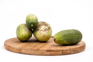 Fresh cucumbers dirty with soil isolated over white background