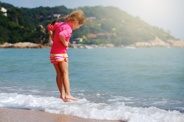 Happy child playing in sea.