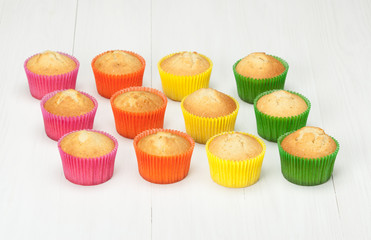 Homemade Colorful Plain Cupcakes On White Table.
