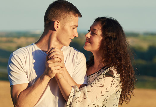 young couple posing on country outdoor in evening, romantic and tenderness concept, summer season