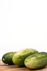 Fresh cucumbers on the round cutting board