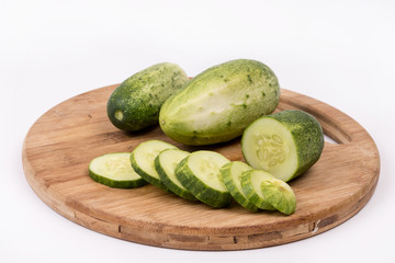 Sliced fresh cucumbers on the round cutting board