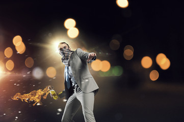 Businessman throwing petrol bomb . Mixed media