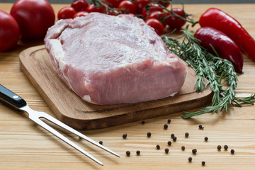 Raw pork ready to Cook on a wooden board