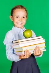 girl in a school uniform with a green apple and books. 