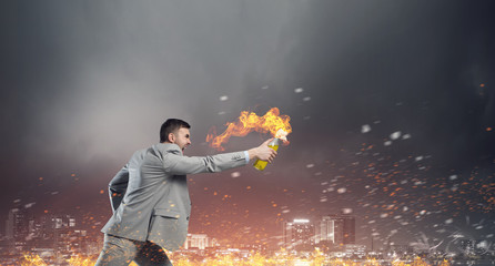 Naklejka premium Businessman throwing petrol bomb . Mixed media