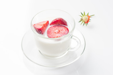 Milk fruit dessert with red strawberries in a cup.