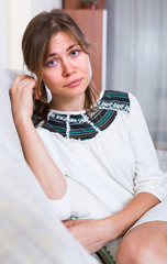Unhappy brunette in domestic interior.