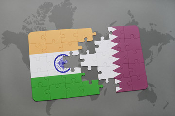 puzzle with the national flag of india and qatar on a world map background.