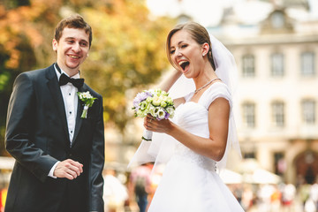 Newlyweds have fun walking along the old streets